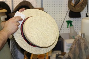 Dusting a straw hat