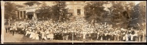 Men and women wear hats and layers at a summer picnic.